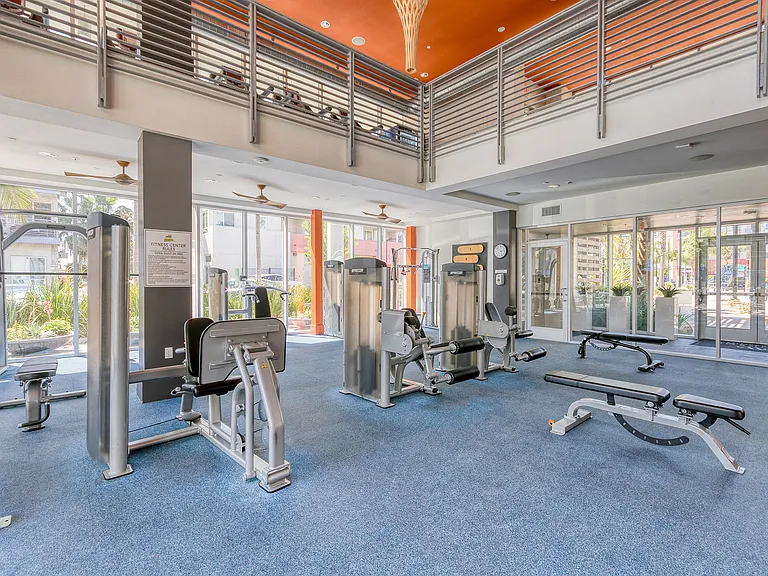 Fitness center complete with cardio machines and weights
