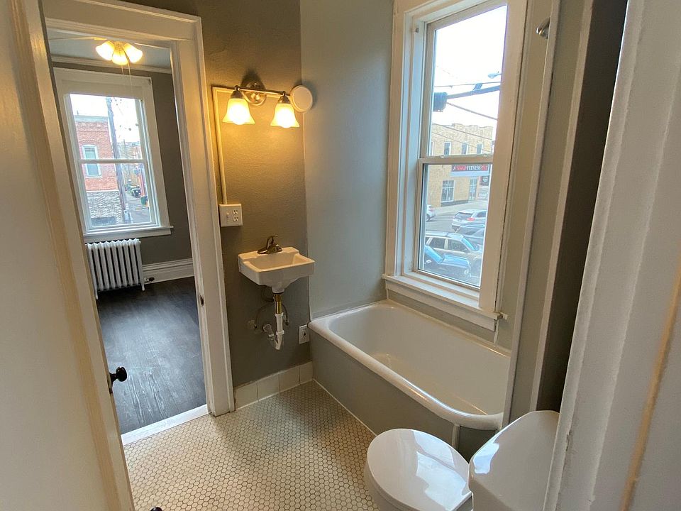 The gorgeous bathrooms feature hexagon style tile with a newly refreshed shower, new toilet, lighting, and sink!