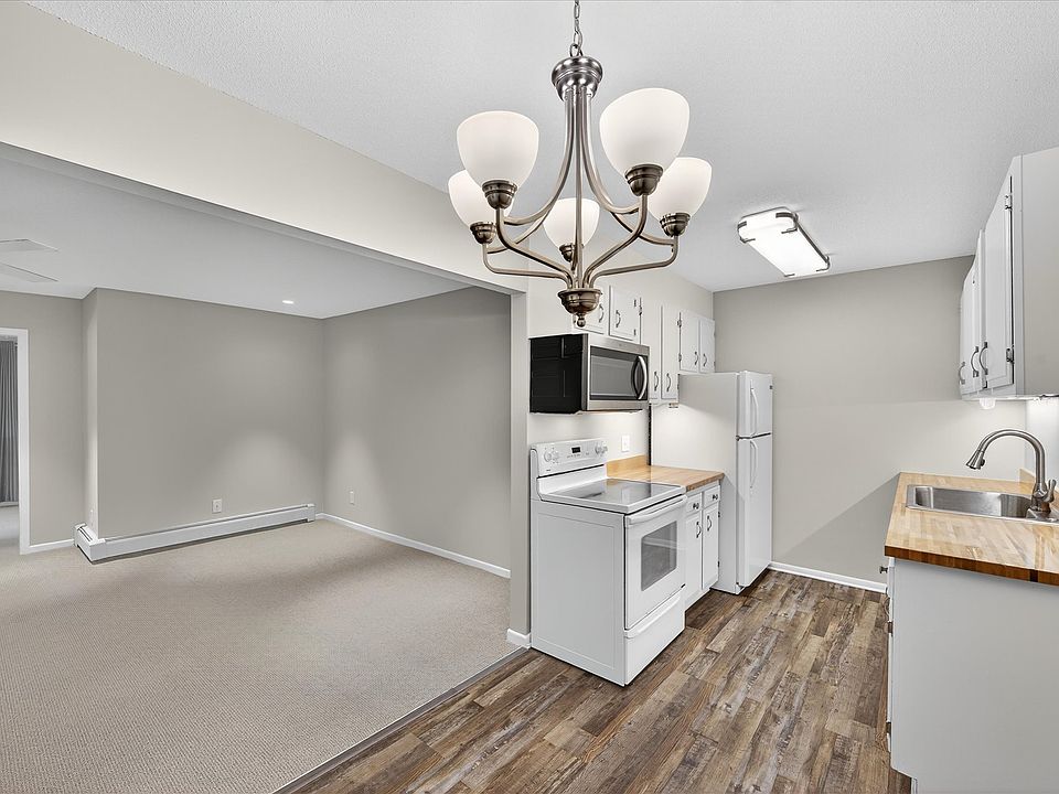 Welcome home with this view of kitchen, dining area and living room from front door. Many updates throughout the unit, including fresh paint and brand spanking new carpet in all rooms and closets!