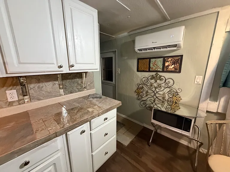 Newly added cabinets and counter with ceramic counter and back splash