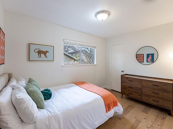 The second bedroom features room for a queen bed, a closet, a spacious dresser, and a window overlooking the back yard.