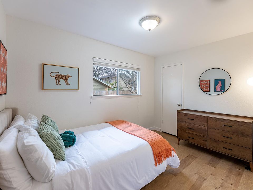 The second bedroom features room for a queen bed, a closet, a spacious dresser, and a window overlooking the back yard.
