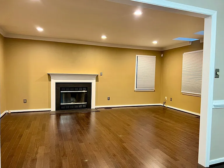 Family Room with fireplace. Windows to the right face the backyard and deck.