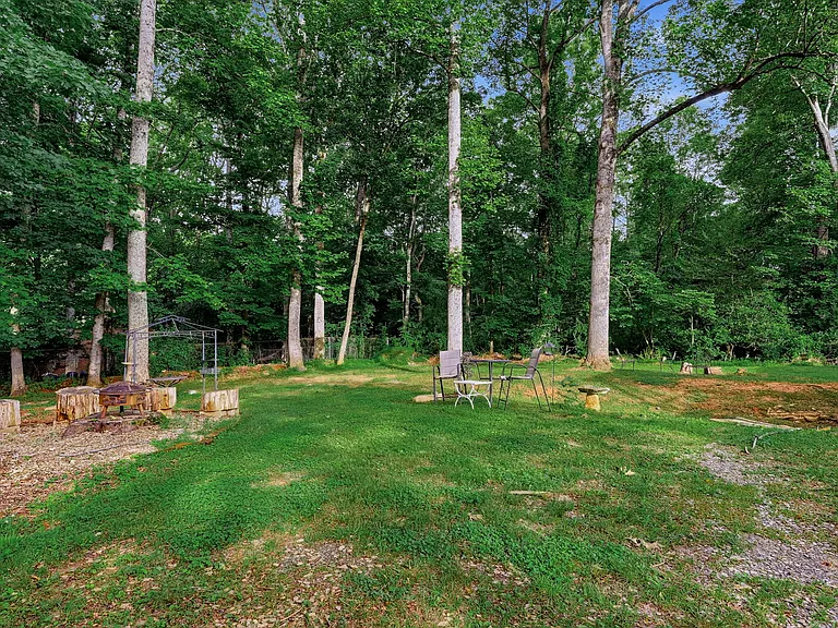 BACK YARD: Large Fire Pit, BBQ Gazebo and Table just beyond, Seating area ahead (Additional Seating area to right, TERRACE LEVEL Door to right)
