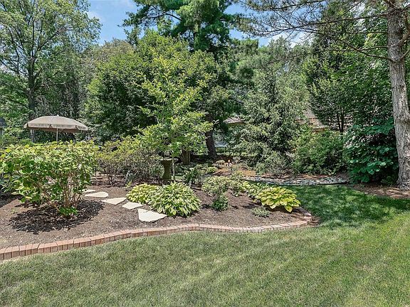 A view of part of the backyard featuring beautiful flora.