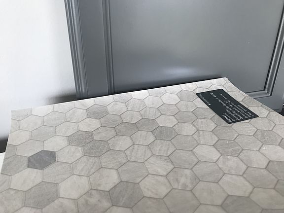 Bathroom cabinets in this cool grey with very pretty vinyl flooring.