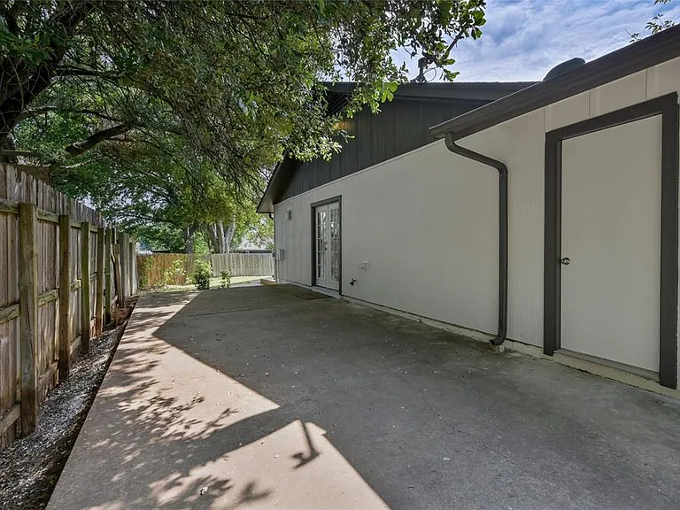 Additional fenced in parking on the side of the house.
