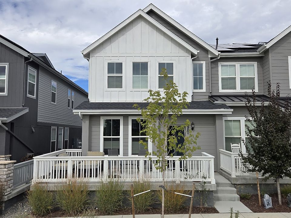 Front of townhome with spacious porch and new plantings starting to mature