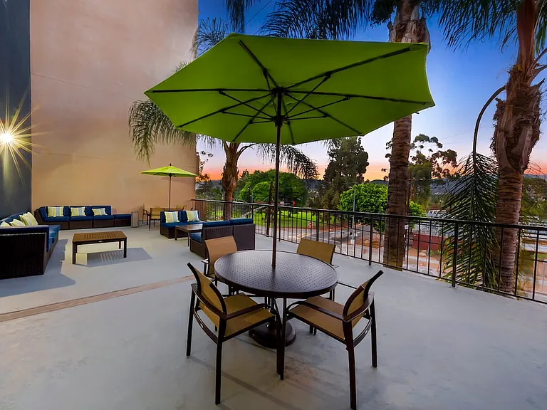 Resident courtyard with barbecue grills, fire pits, and lounge seating