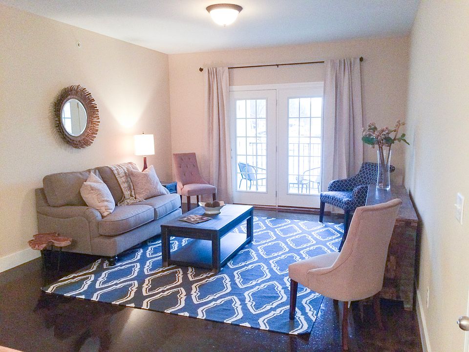 Bright, open, and inviting. This spacious living room features French doors that lead straight to your private patio or balcony for effortless indoor outdoor living.