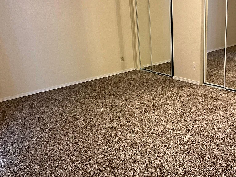 Primary bedroom with private bath and full wall of closets