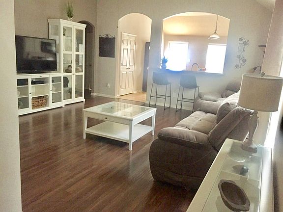 View from entryway open to the Living Room and Kitchen