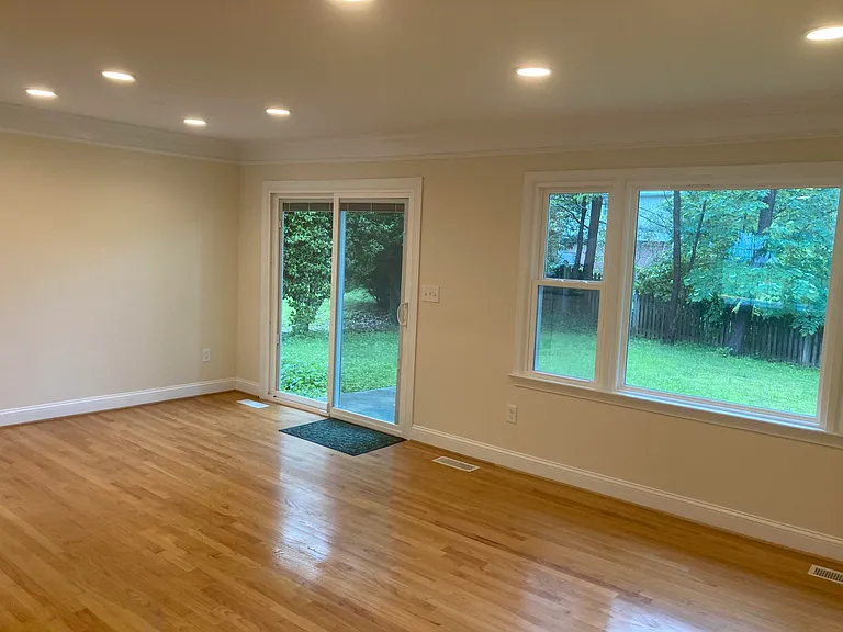 Dining room view of sliding glass door with built-in shades.