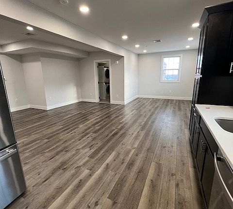 Full view of the kitchen into dining room and living room