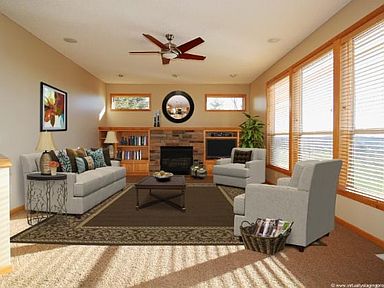 Maim floor Great room is bright and sunny, has fireplace, built-ins, wood blinds, and pillars