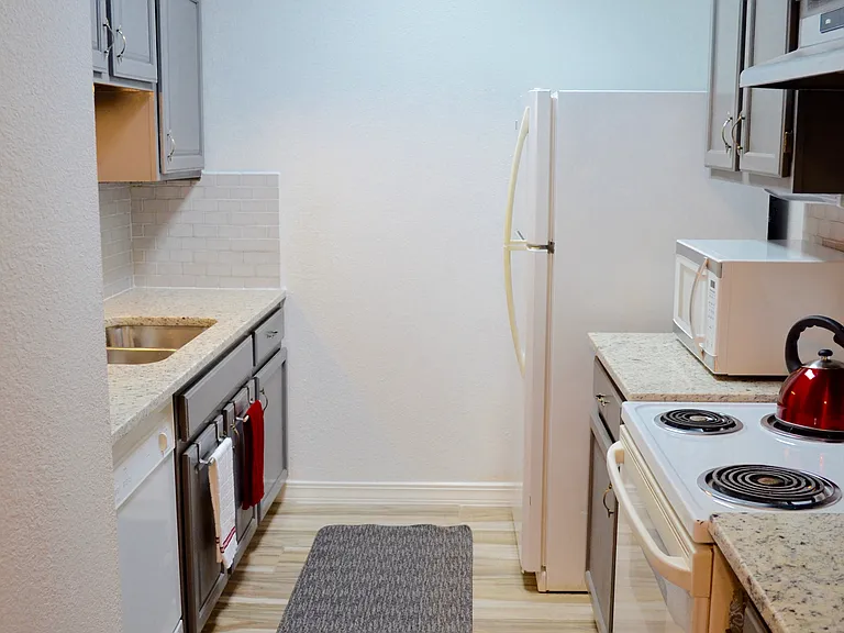 Galley kitchen. Granite countertops.