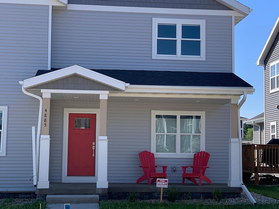 Front porch with red chairs