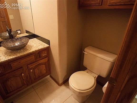 Half bath on main level, with tub sink, granite counter top and marble tile floo