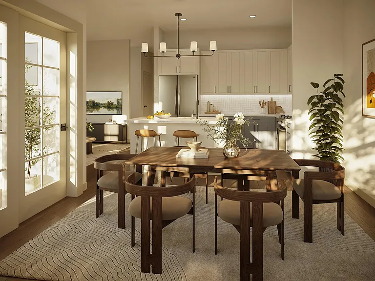 A bright kitchen and dining space with streamlined cabinetry, layered lighting, and an open layout designed for effortless hosting.