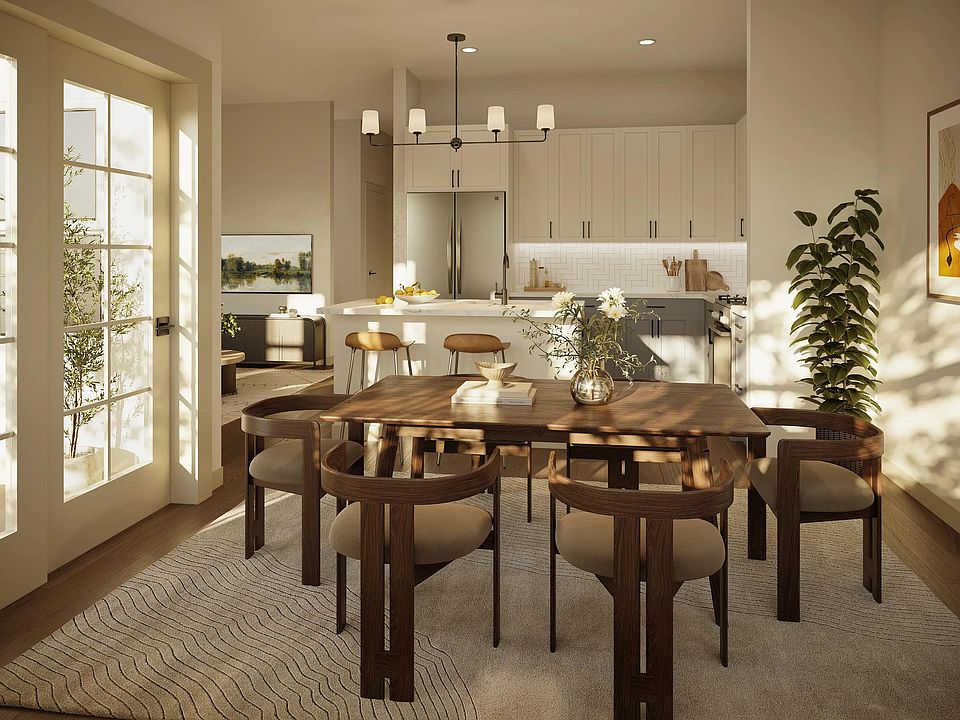 A bright kitchen and dining space with streamlined cabinetry, layered lighting, and an open layout designed for effortless hosting.