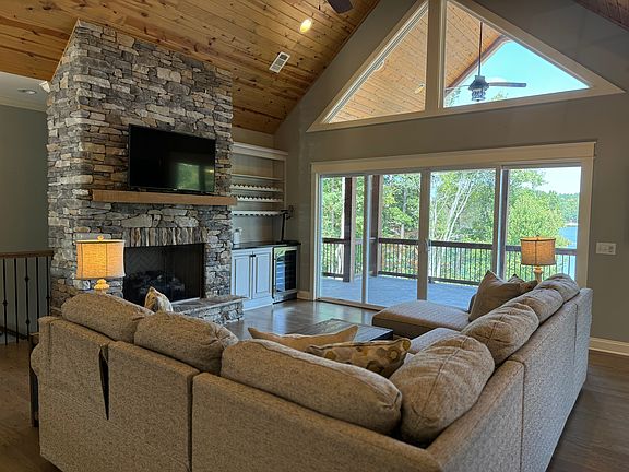 Large living room with gas fireplace, smart tv. Open floor plan with kitchen and dining room.