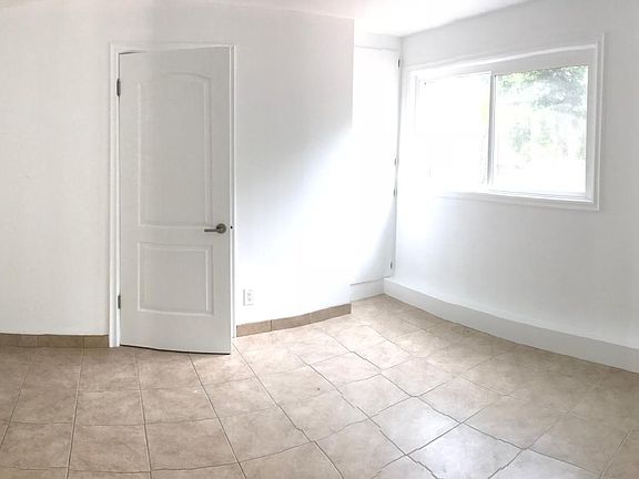 Bedroom with window looking to the patio.