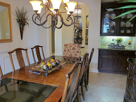 FORMAL DINING ROOM WITH CUSTOM BUILT IN HUTCH: TILE BACKSPLASH, GLASS DOORS, UNDER MOUNT LIGHTING