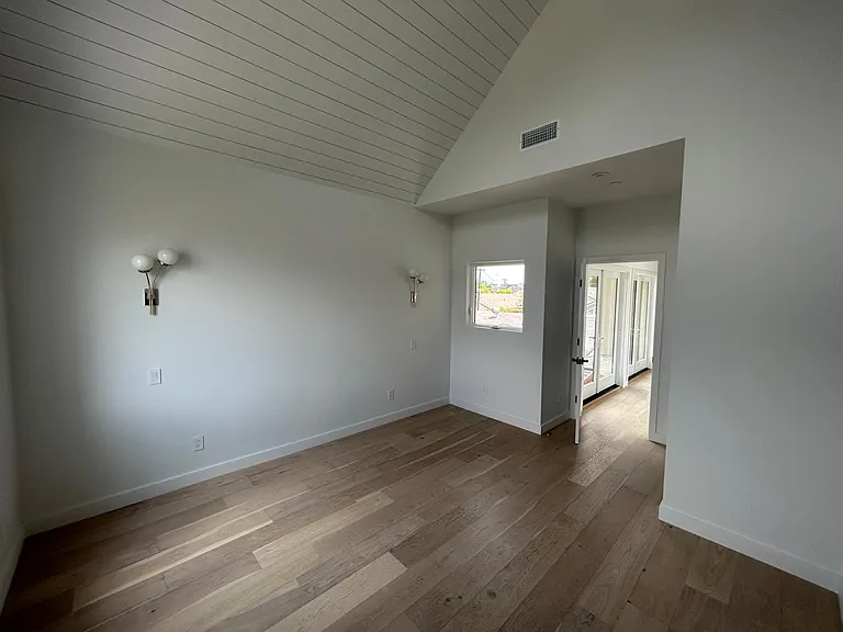 Bedroom with oversized windows high ceilings and walk-in closet private bathroom