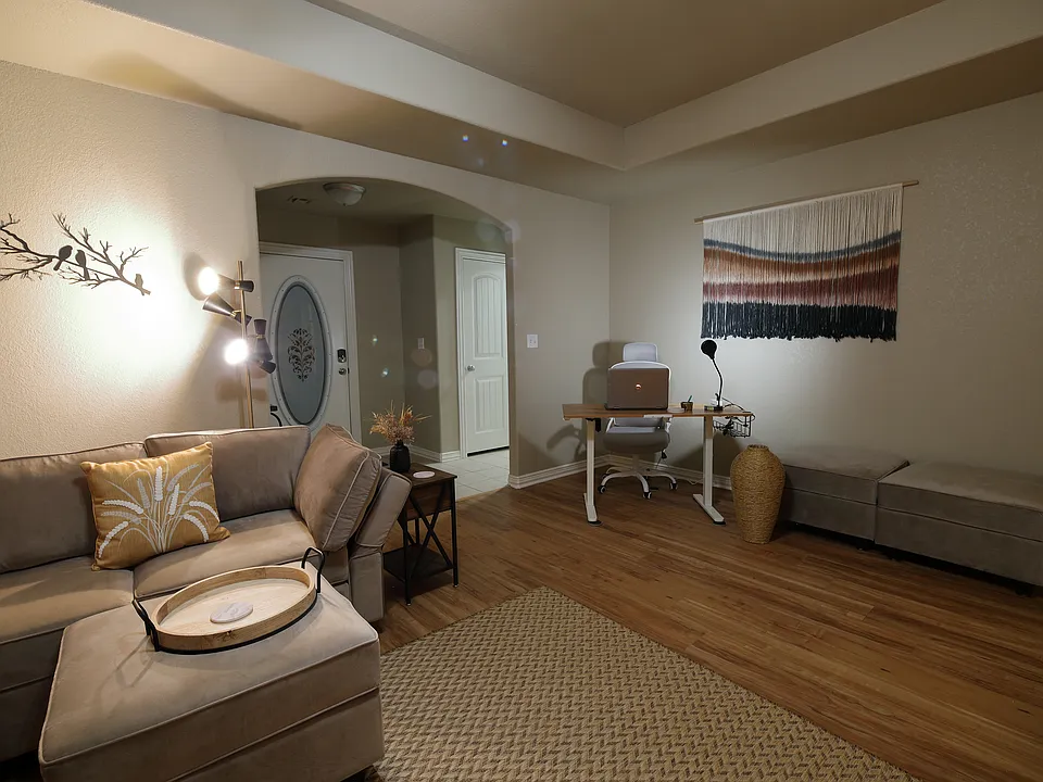 Livingroom with Desk entry way leading into laundry room.