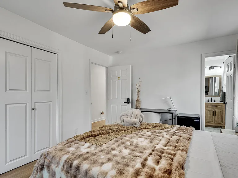 The bedroom toward the door and bath entry: Your own locked door, your own bathroom, your own peaceful corner.
