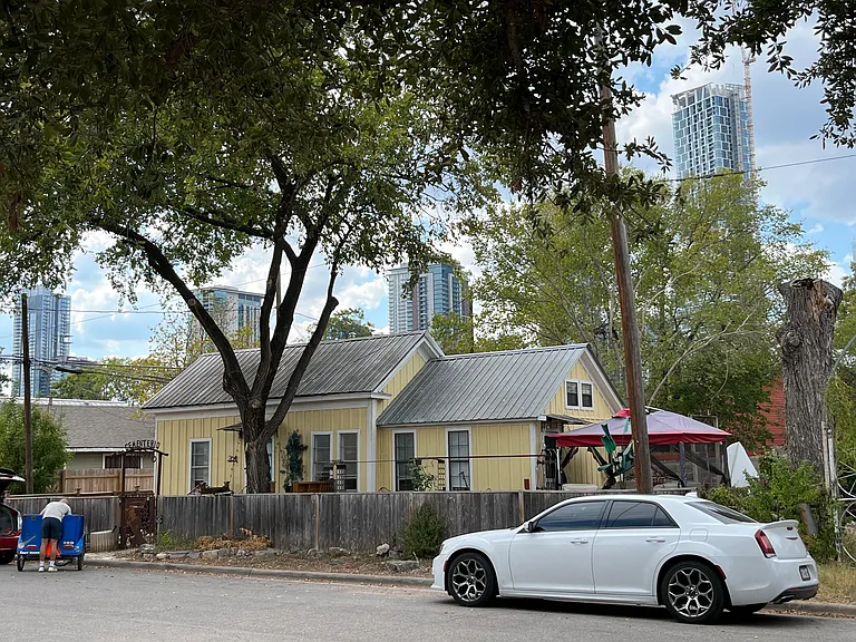 View across the street of neighbor and downtown skyline.