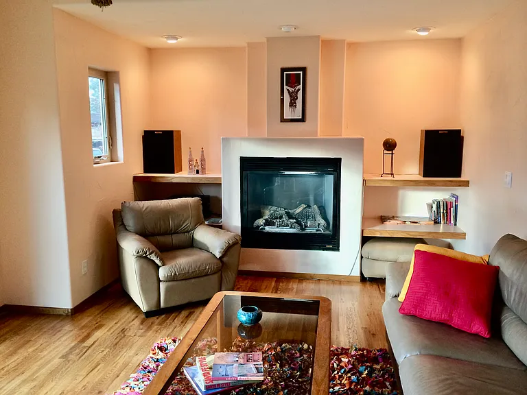 Inviting living room with real hardwood floors and a gas fireplace.
