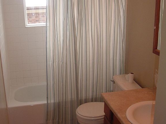 Bathroom is remodeled with new paint, tile and sink/countertop