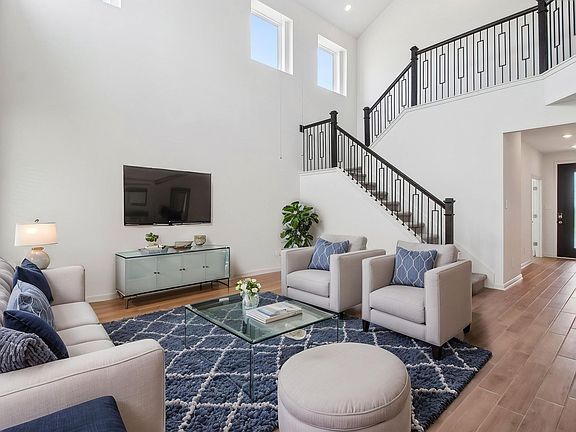 Virtually staged living room in the Pine floorplan at a Meritage Homes community.