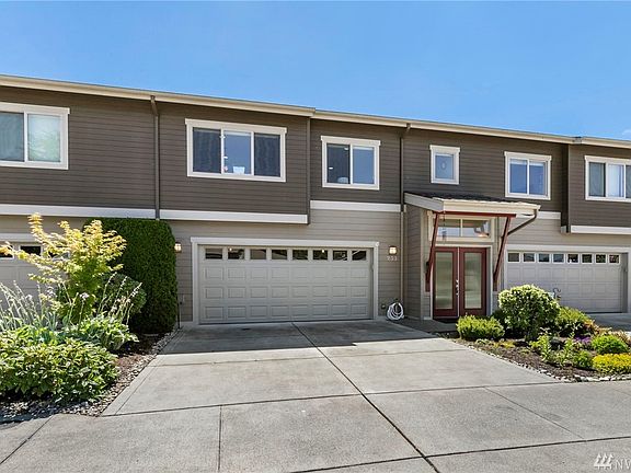 Welcome home!  Two car garage, with driveway parking too. Those red doors lead to your oasis. 