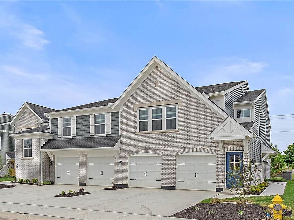 This modern townhome features a brick and siding f