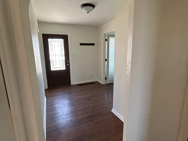 Front door opens to entry area with beautiful archway, access to upstairs, and a room that can be used as an office, bedroom, dining room, TV room, or whatever suits your needs!