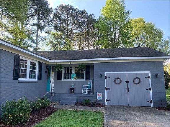 Adorable barn door style garage doors!  Converted to a half storage space and half is used as a laundry room/4th bedroom with a concrete floor.