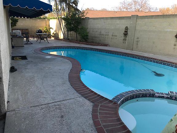 Swimming Pool and spa. Owner pays for pool maintenance. Backyard has plum, orange and peach trees with a few palm trees as well. Owner pays for gardening.