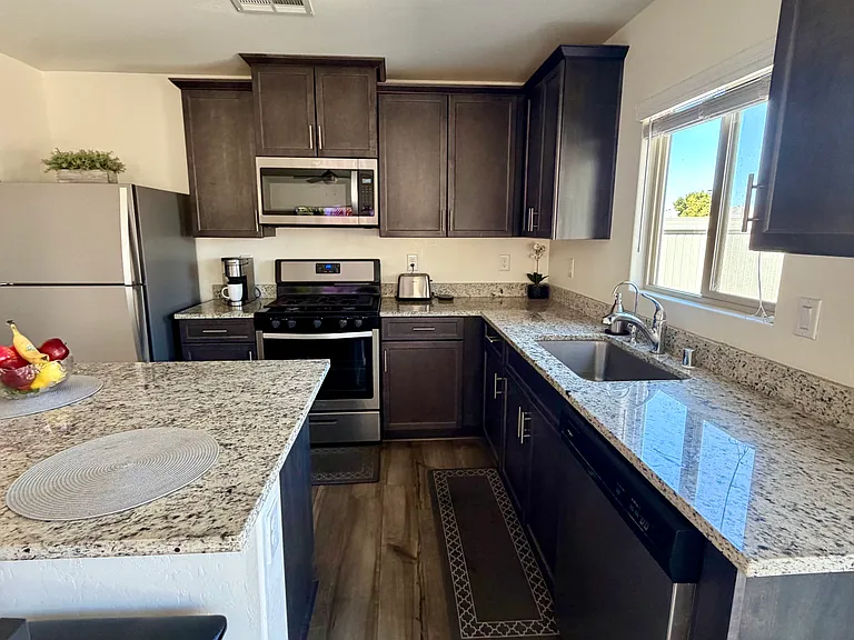 Fully equipped kitchen - dishwasher, stove, microwave, fridge, freezer, toaster, pots, pans, cooking utensils, wine glasses, cups, plates, silverware