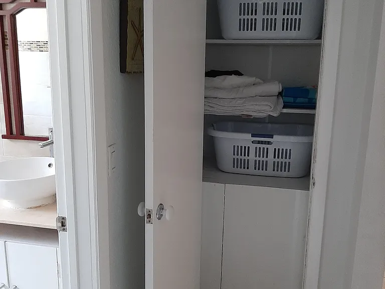 Additional closet / storage area located outside guest bathroom.