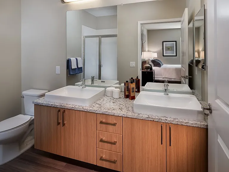Traditional Collection Bath with oak cabinetry, grey granite countertop, and hard surface flooring