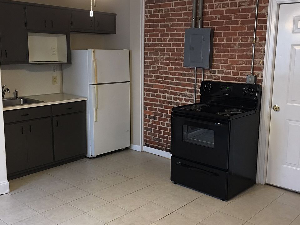 kitchen area with fridge and stove