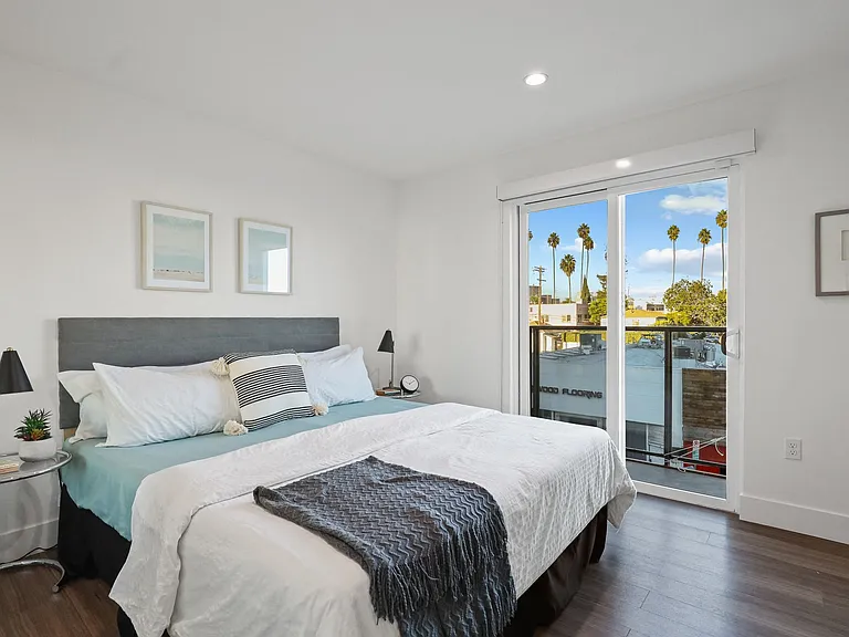 Spacious Bedrooms with Vinyl Flooring, Recessed Lighting, and Balcony Access