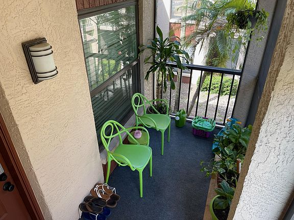 Front balcony patio view from screen door entrance.