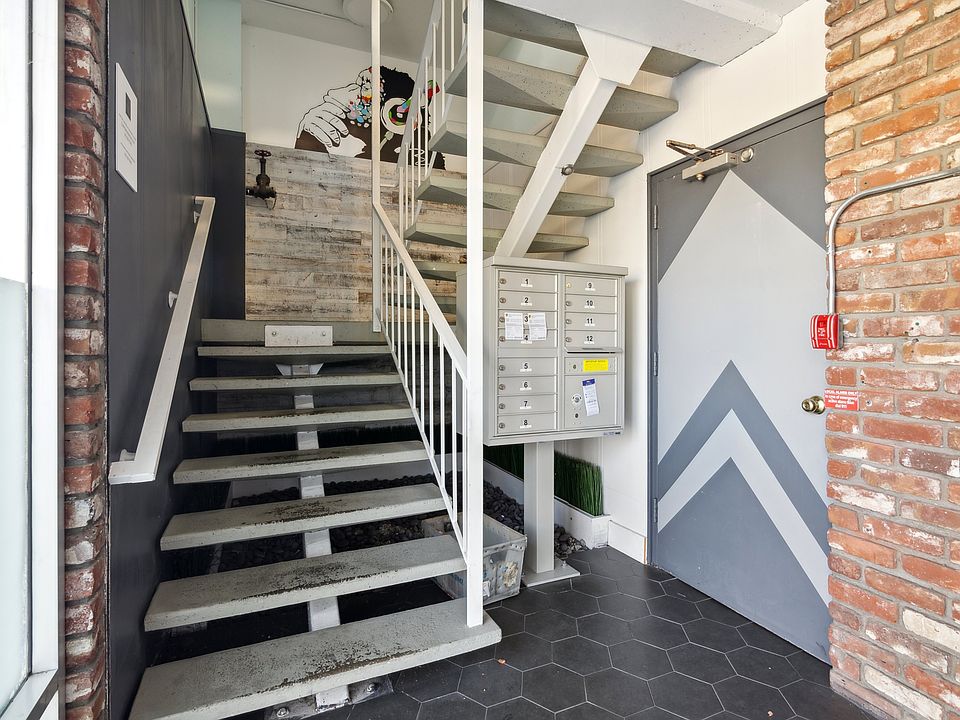Residential hallway with staircase and mailboxes