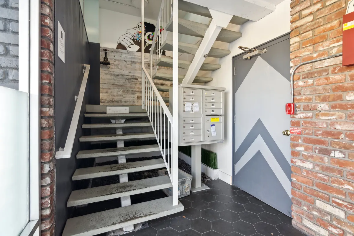 Residential hallway with staircase and mailboxes - 2252 Parker