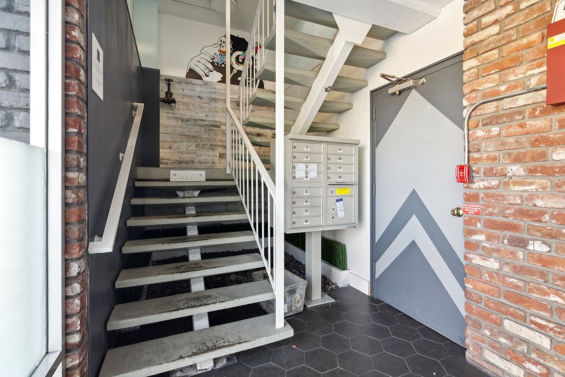 Residential hallway with staircase and mailboxes