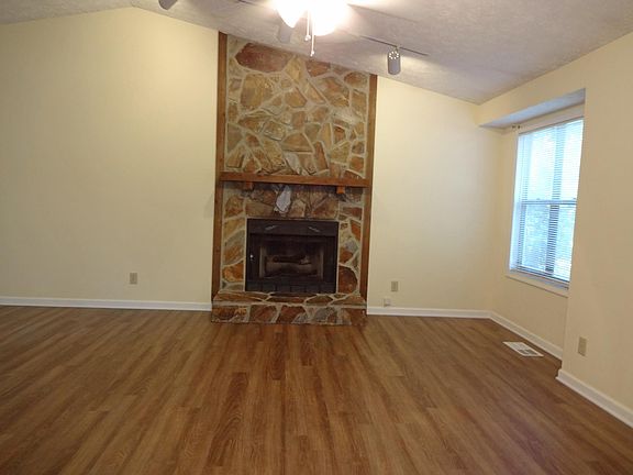 Large living room, stone floor to ceiling fireplace with gas logs. New wood floors.