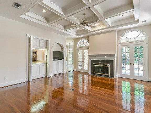 The family room has wood floors (just refinished), coffered ceiling, wet bar, gas fireplace, recessed lighting and a ceiling fan.